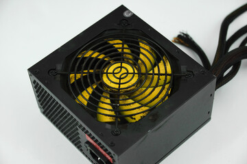 Dusty, dirty power supply. Black case, yellow propeller power supply. Uncleaned, dusty power supply.