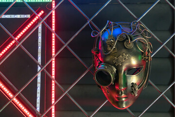 Women's iron steampunk mask. Halloween or masquerade mask. Background from iron bars and...