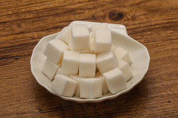 Refined white sugar cubs in the bowl