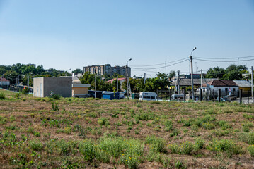 Tiraspol, Transdniester, 1 September 2017. Grass field and homes in a residential area on the outskirts of Tiraspol.