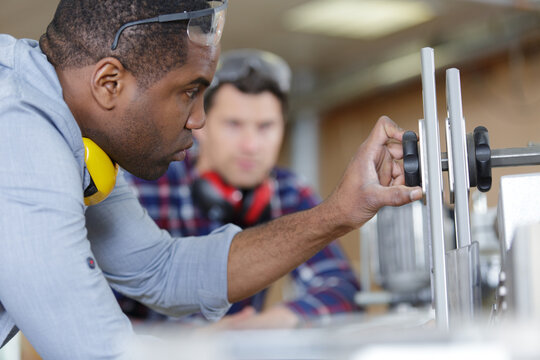 carpentry apprentice learning to use circular saw