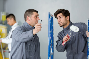 industrial painting contractor manager giving instructiosn