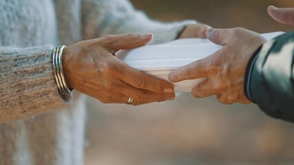 woman volunteer help feed the homeless with free meal. Close-Up. . High quality photo