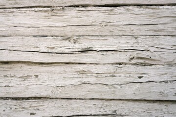 Rough white background of vintage wooden building wall. Painted timber in cracks.