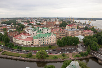 Fototapeta na wymiar Top view of the beautiful old town, water and cozy colored houses, Russia, Vyborg. 