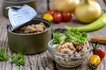 Canned tuna salad on the wooden background