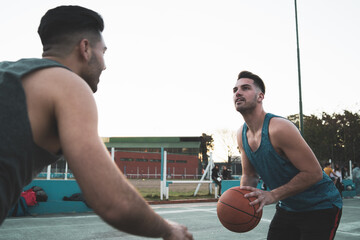 Young basketball players playing one-on-one.