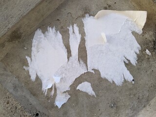 old and empty public Bulletin Board with the remains of torn papers