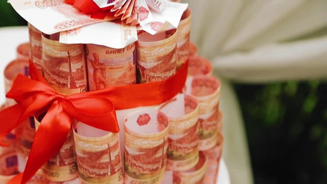 Close up of the tower of banknotes standing on the table