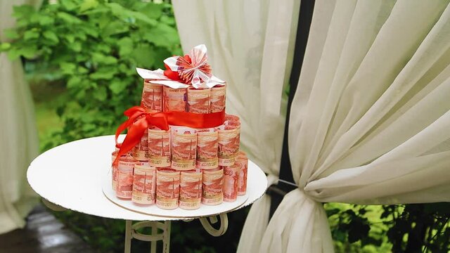 A large tower of banknotes stands on the table. Taken with a general plan