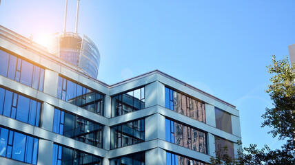 Office building, details of blue glass wall and sun reflections.