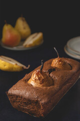 Homemade vegan chocolate cake with poached pears. Close-up view.