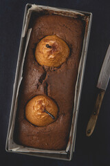 Homemade vegan chocolate cake with poached pears. Top view, flat lay.