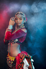 Fototapeta na wymiar Belly dancer, Indian and flamenco dancer. Ancient prefab costumes are multi-layered Indian skirts, Afghan, Yemeni antique jewelry, many colors, iron and wealth.