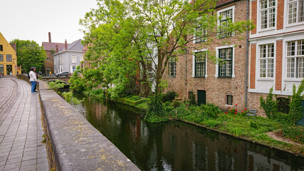 Naklejka na ściany i meble Beautiful View Of Authentic Houses Above The Canal In The Belgian City Of Bruges.