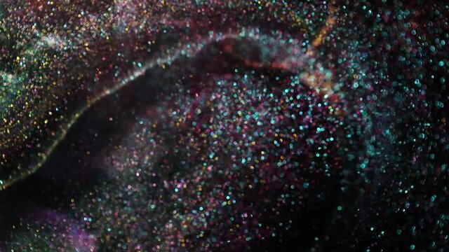 Festive bokeh lights background video. Abstract shiny backdrop with circles in motion. Footage with liquid twinkling particles. Colored and bright fluent animation with blur effect