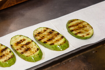 Grilled zucchini with strips in the kitchen in a restaurant
