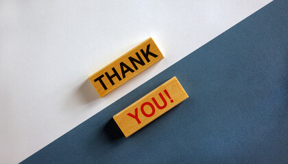 Concept words 'thank you' on wooden blocks on a beautiful white and blue background. Business...