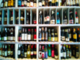 Alcohol showcase blurred background. Blurred abstract background of shelf in supermarket