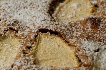 top view closeup of apple pie (charlotte) with cinnamon and sugar powder