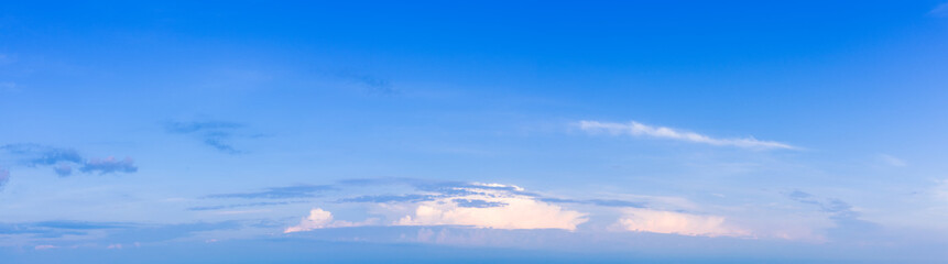 White clouds on a background of blue sky. Panorama
