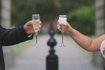 bride and groom raising champagne glasses to a happy life together