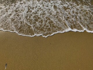 Waves and golden sand on the beach