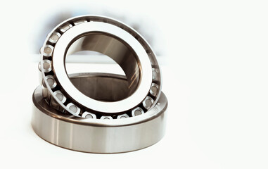 Mechanical spare part on a white background. Close-up Tapered roller bearing with space for text