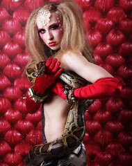 woman with creative make up holding Python