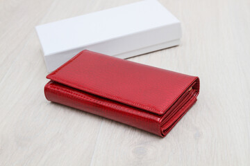 closed red women's wallet on a gray background