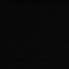 A black vintage rough sheet of carton. Recycled environmentally friendly cardboard paper texture. Simple gray minimalist papercraft background.