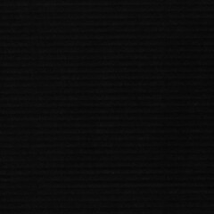 A black vintage rough sheet of carton. Recycled environmentally friendly cardboard paper texture. Simple gray minimalist papercraft background.