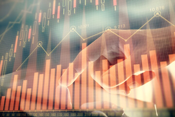 Multi exposure of man's hands holding and using a phone and financial chart drawing. Market analysis concept.