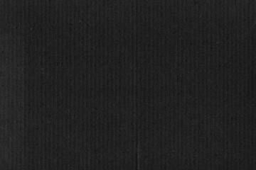 Fototapeta premium A black vintage rough sheet of carton. Recycled environmentally friendly cardboard paper texture. Simple gray minimalist papercraft background.