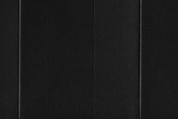 Fototapeta premium A black vintage rough sheet of carton. Recycled environmentally friendly cardboard paper texture. Simple gray minimalist papercraft background.