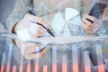 Double exposure of forex chart sketch hologram and woman holding and using a mobile device. Financial market concept.