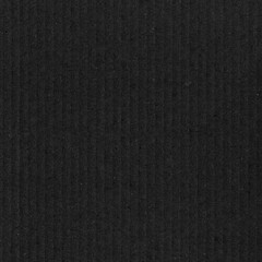 A black vintage rough sheet of carton. Recycled environmentally friendly cardboard paper texture. Simple gray minimalist papercraft background.