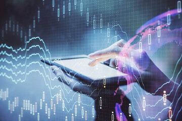 Double exposure of forex chart sketch hologram and woman holding and using a mobile device....