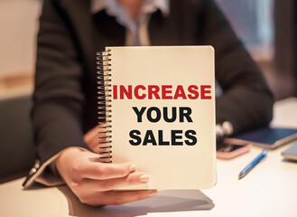 Increase your sales - text on notepad. Business concept