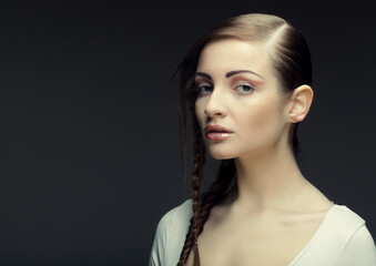 portrait of beautiful young blonde woman with creative braids ha