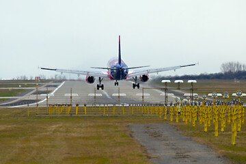 Landing of a passenger plane, strong heat haze vibration tubulance in the air, runway lights