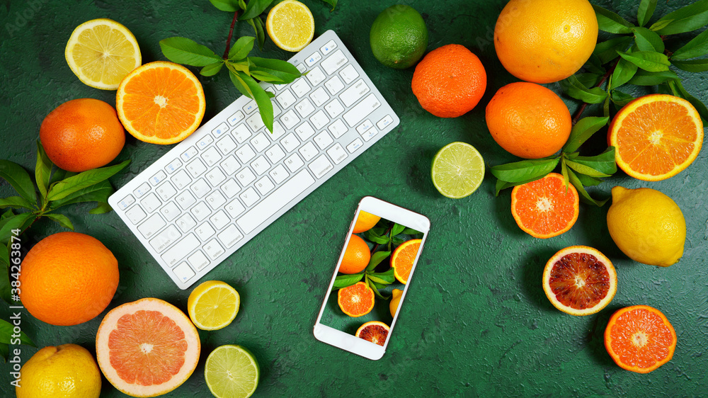 Wall mural health food theme background workspace with citrus fruit on dark green textured background. top view