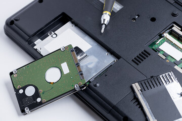 technician worker repairing laptop pc. restore hard disk data store concept. computer hardware repair service conceptual. person checking hdd disk