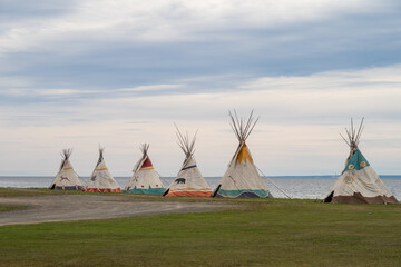 View of aligned tipis in Gesgapegiag, an indian reserve, located in Canada