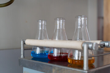 Medical and chemical glassware equipment: erlenmeyer flasks with multi colored liquid inside