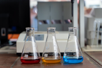 Medical and chemical glassware equipment: erlenmeyer flasks with multi colored liquid inside