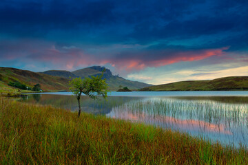Beautiful Sunrise cloud colours at Loch Fada on the Isle of Skye with the Old man of Storr in the Background