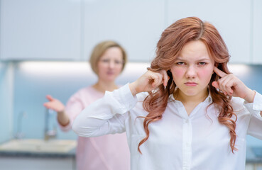 Mom in the process of littering with a child swings a fist at her teenage daughter, the child...