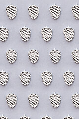 Christmas pattern with silver cones on a grey background. Festive winter background