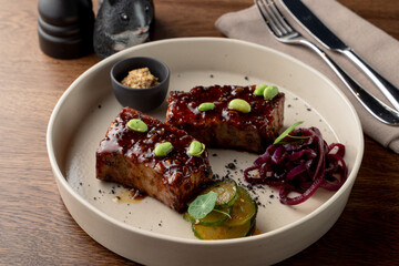 Tofu steak, marinated in teriyaki sauce and served with edamame beans, gourmet meal in a fancy restaurant, top view